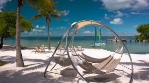 A hammock on the beach with some other chairs down in the Florida Keys.